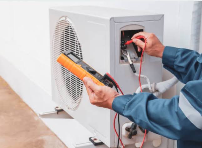 Technician testing HVAC equipment with diagnostic instruments